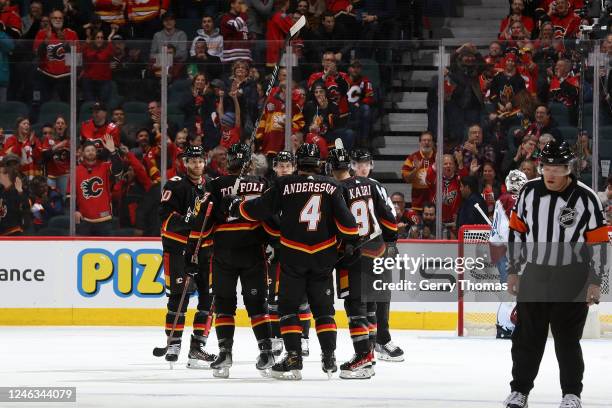 Rasmus Andersson of the Calgary Flames celebrates with teammates after a goal against the Colorado Avalanche at Scotiabank Saddledome on January 18,...