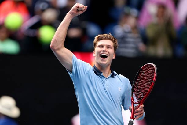 S Jenson Brooksby celebrates victory against Norway's Casper Ruud during their men's singles match on day four of the Australian Open tennis...