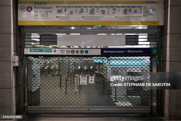 This photograph taken on January 19, 2023 shows metal curtain closing off access to Montparnasse metro station in Paris, as workers go on strike over...