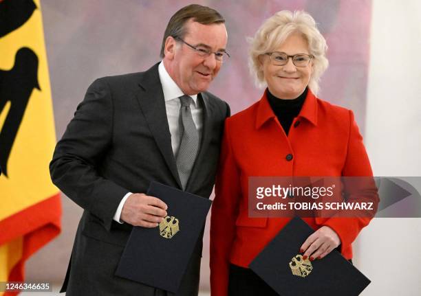 Germany's former Defence Minister Christine Lambrecht and her successor Boris Pistorius pose for a picture after they were handed over respective...