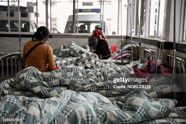 This photo taken on January 9, 2023 shows patients with Covid-19 coronavirus resting in a hospital in Jinghong City in Xishuangbanna Dai Autonomous...