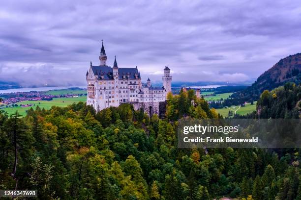 Neuschwanstein Castle on a cloudy evening in autumn, seen from the bridge Marienbrücke, built high above the Pöllat Gorge.