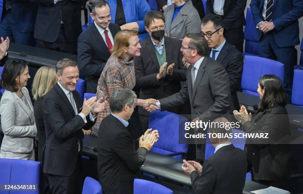 Germany's new Defence Minister Boris Pistorius shakes hands with German Minister for Family Affairs, Senior Citizens, Women and Youth Lisa Paus and...