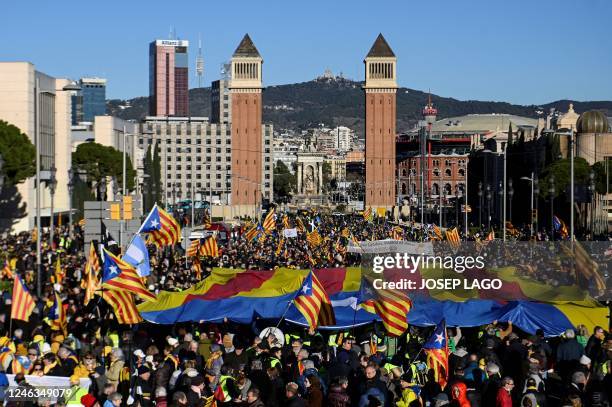 Protestors wave a giant Catalan pro-independence "Estelada" flag during a demonstration on the sidelines of a Franco-Spanish summit in Barcelona on...