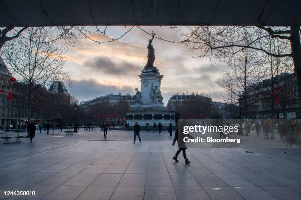 Commuters walk through Place de La Republique, during a national strike against government plans to revamp the pension system, in Paris, France, on...
