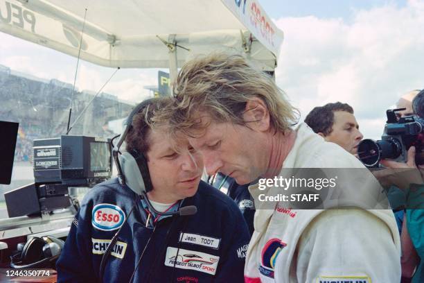 Peugeot Talbot Sport manager Jean Todt talks to French Jean-Pierre Jabouille , one of the drivers of the Peugeot Talbot Sport 905 N°5, 6 hours after...