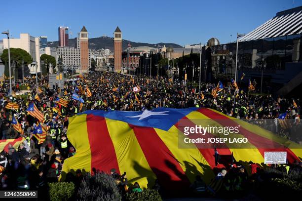 Protestors wave a giant Catalan pro-independence "Estelada" flag during a demonstration on the sidelines of a Franco-Spanish summit in Barcelona on...