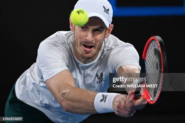 Britain's Andy Murray hits a return against Australia's Thanasi Kokkinakis during their men's singles match on day four of the Australian Open tennis...