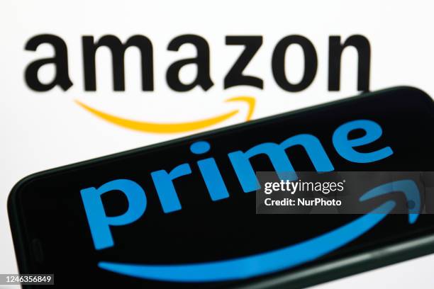 Prime logo displayed on a phone screen and Amazon logo displayed on a screen in the background are seen in this illustration photo taken in Krakow,...