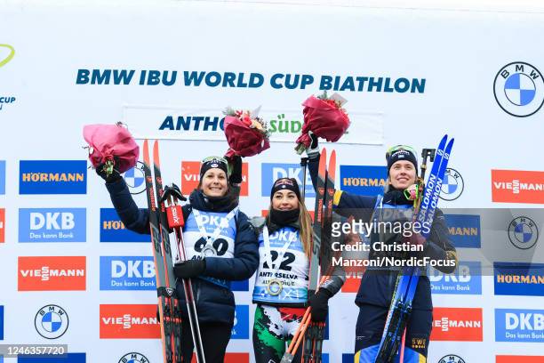 Second placed Chloe Chevalier of France, race winner Dorothea Wierer of Italy and third placed Elvira Oeberg of Sweden celebrate on the podium after...