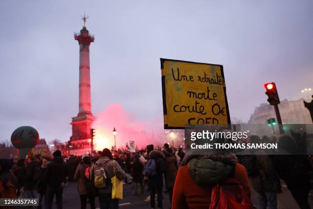 Protester holds a placard reading " a dead retiree costs zero euro " in Place de la Bastille during a rally called by French trade unions in Paris on...