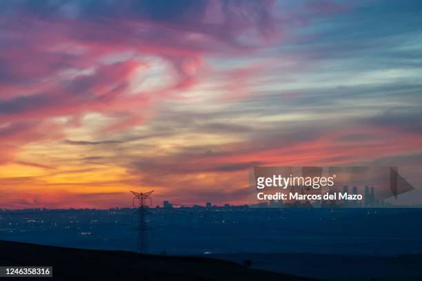 Electricity high voltage tower is seen with the skyline of Madrid during sunset. The year 2022 in Spain has closed with the highest electricity bill...