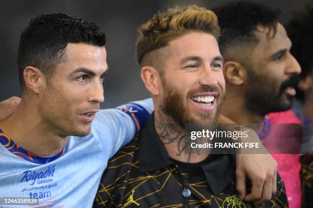 Paris Saint-Germain's Spanish defender Sergio Ramos chats with Riyadh All-Star's Portuguese forward Cristiano Ronaldo during the Riyadh Season Cup...