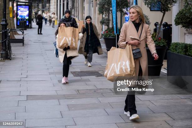 Woman and a child carrying Zara shopping bags along Brompton Road in Knightsbridge on 13th January 2023 in London, United Kingdom.