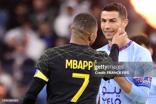 Paris Saint-Germain's French forward Kylian Mbappe greets Riyadh All-Star's Portuguese forward Cristiano Ronaldo during the Riyadh Season Cup...