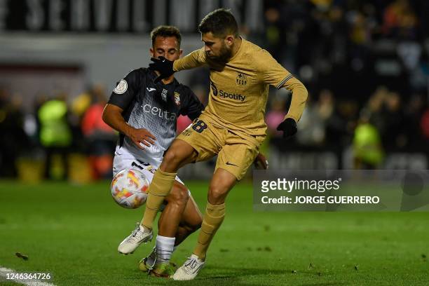Ceuta's Spanish defender Alain Garcia fights for the ball with Barcelona's Spanish defender Jordi Alba during the Spain's Copa del Rey , round of 16...