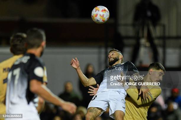 Ceuta's Spanish midfielder Nito Gonzalez and Barcelona's Spanish defender Hector Bellerin jump for the ball during the Spain's Copa del Rey , round...