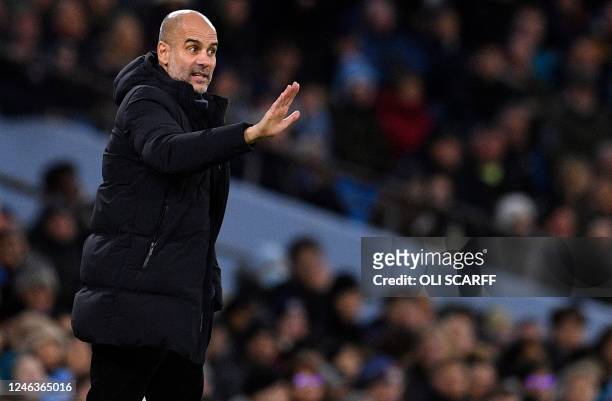 Manchester City's Spanish manager Pep Guardiola shouts instructions to the players from the touchline during the English Premier League football...