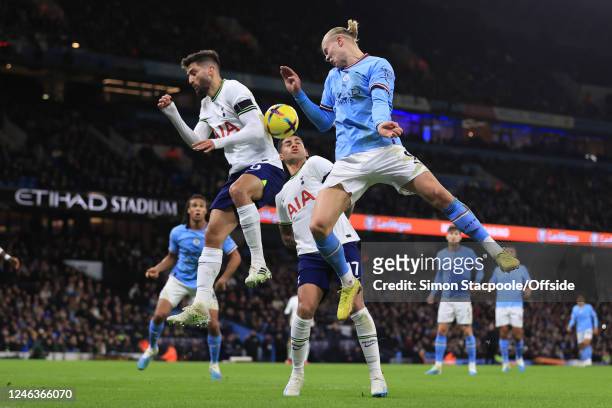 Erling Haaland of Manchester City jumps for the ball with Rodrigo Bentancur of Tottenham Hotspur watched by Cristian Romero of Tottenham Hotspur...
