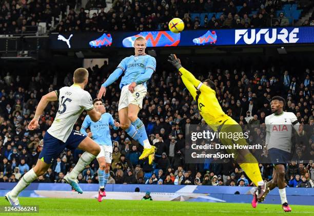 Manchester City's Erling Haland heads over the bar under pressure from Tottenham Hotspur's Hugo Lloris during the Premier League match between...