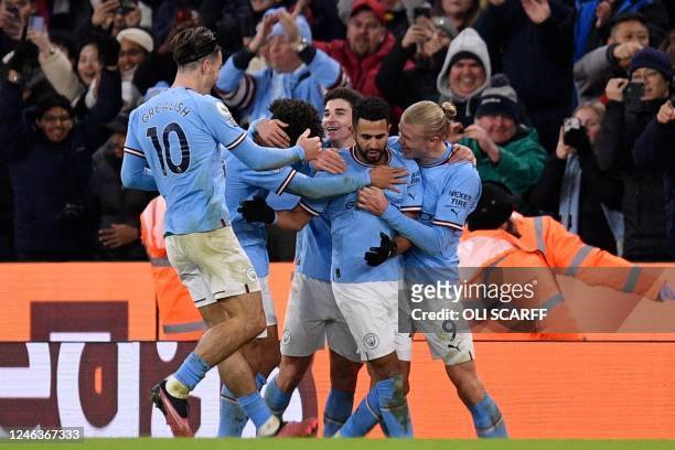 Manchester City's Algerian midfielder Riyad Mahrez celebrates scoring the team's third goal with Manchester City's Norwegian striker Erling Haaland...