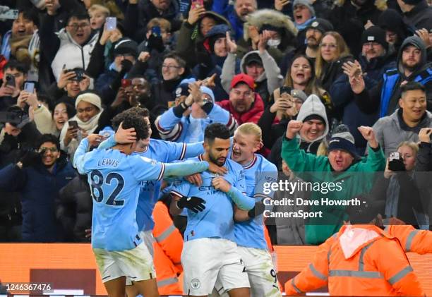 Manchester City's Riyad Mahrez celebrates scoring his side's third goal with teammates during the Premier League match between Manchester City and...