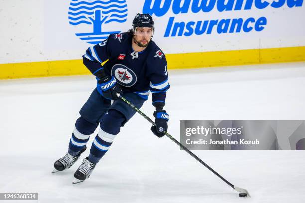 Brenden Dillon of the Winnipeg Jets plays the puck during third period action against the Arizona Coyotes at Canada Life Centre on January 15, 2023...