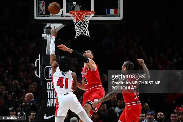 Detroit Pistons' US forward Saddiq Bey shoots to score in front of Chicago Bulls' Montenegrin center Nikola Vucevic and Chicago Bulls' US power...