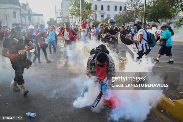 Demonstrators clash with riot police during a protest against the government of President Dina Boluarte in Lima on January 19, 2023. - Lima was on...