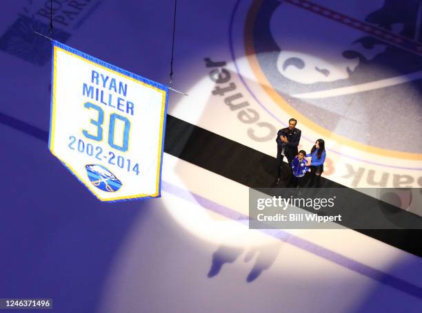 Former Buffalo Sabres goaltender Ryan Miller poses with his family as his number 30 is raised to the rafters during a ceremony prior to the NHL game...