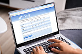 Woman Looking At Online Survey Laptop Computer