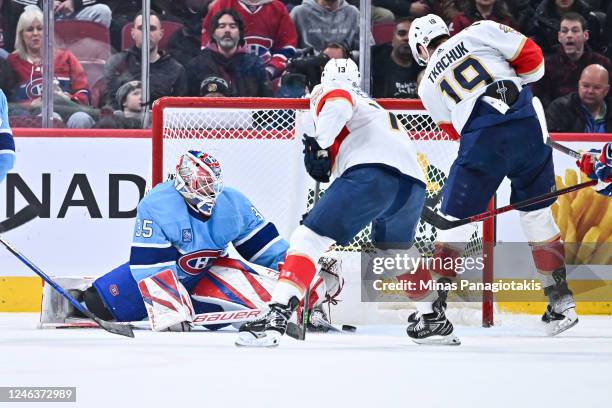 Goaltender Sam Montembeault of the Montreal Canadiens makes a skate save near Sam Reinhart and Matthew Tkachuk of the Florida Panthers during the...