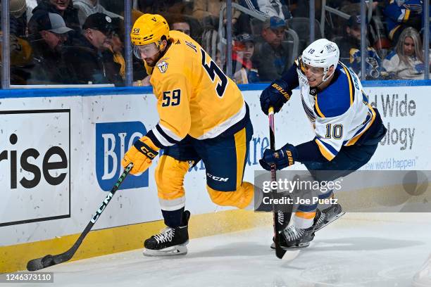 Brayden Schenn of the St. Louis Blues pressures Roman Josi of the Nashville Predators at the Enterprise Center on January 19, 2023 in St. Louis,...