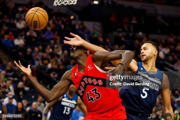 Pascal Siakam of the Toronto Raptors and Kyle Anderson of the Minnesota Timberwolves battle for a rebound in the first quarter at Target Center on...