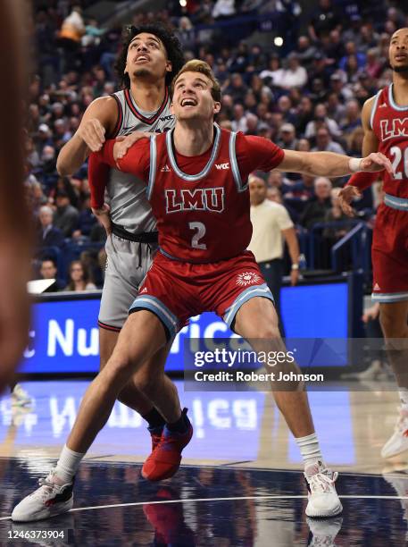 Justin Ahrens of the Loyola Marymount Lions boxes out against Anton Watson of the Gonzaga Bulldogs during the first half of the game at McCarthey...