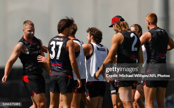 Jake Stringer and teammate Mason Redman of the Bombers are separated by teammates after a clash during the Essendon Bombers training session at The...