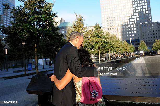 Former New York Gov. George Pataki hugs Anthula Katsimatides, who lost her brother on 9/11, at the North Pool of the 9/11 Memorial during the tenth...