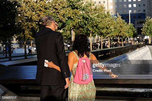 Former New York Gov. George Pataki stands with Anthula Katsimatides, who lost her brother on 9/11, at the North Pool of the 9/11 Memorial during the...