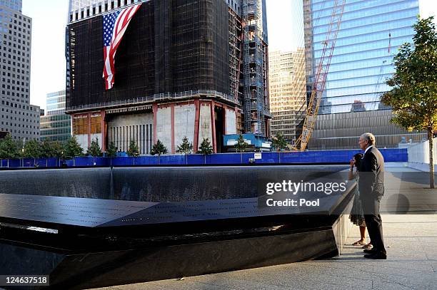Former New York Gov. George Pataki stands with Anthula Katsimatides, who lost her brother on 9/11, at the North Pool of the 9/11 Memorial during the...