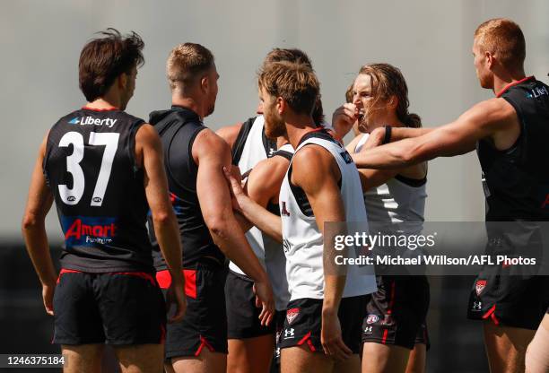 Jake Stringer and teammate Mason Redman of the Bombers are separated by teammates after a clash during the Essendon Bombers training session at The...