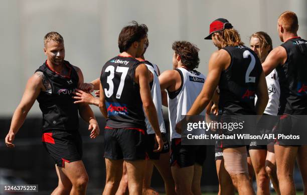 Jake Stringer and teammate Mason Redman of the Bombers are separated by teammates after a clash during the Essendon Bombers training session at The...