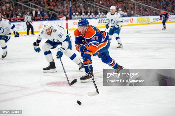 Connor McDavid of the Edmonton Oilers and Erik Cernak of the Tampa Bay Lightning battle for the puck during the second period at Rogers Place on...