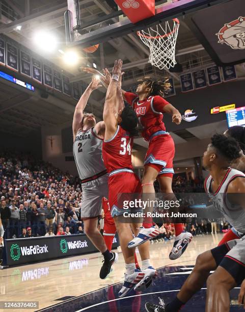 Michael Graham of the Loyola Marymount Lions with the help of forward Keli Leaupepe blocks this shot by Drew Timme of the Gonzaga Bulldogs to...