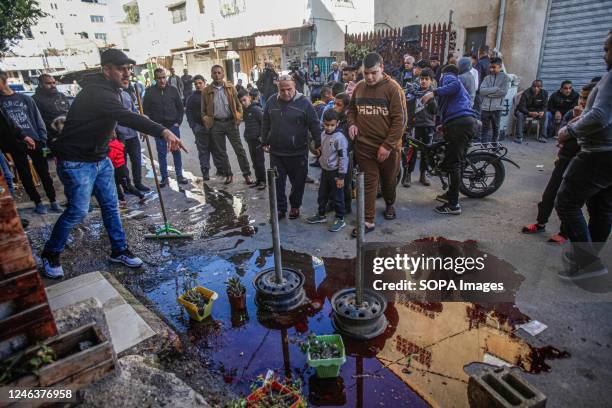 Palestinians inspect the place where the two Palestinians were killed, Adham Jabareen, 28 years old, and school teacher Farid Bawaqna, 57 years old,...