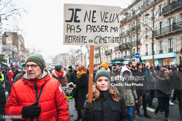 Demonstrator holds a sign with the slogan ''I don't want to spend my retirement in the cemetery'' in the procession of tens of thousands of people...