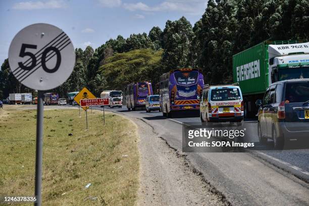 Vehicles drive past road signs placed at a recently declared black spot 5km west of Nakuru Town on the busy Nakuru-Nairobi Highway. In 2022, Kenya...
