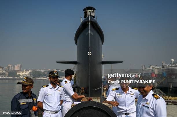 Indian navy officers interact on the deck of fifth Kalvari-Class submarine 'Vagir' anchored at the naval base ahead of its commissioning ceremony in...