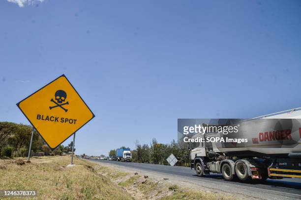 Vehicles drive past a road sign warning motorists of a black spot 5km west of Nakuru Town on the busy Nakuru-Nairobi Highway. In 2022, Kenya recorded...