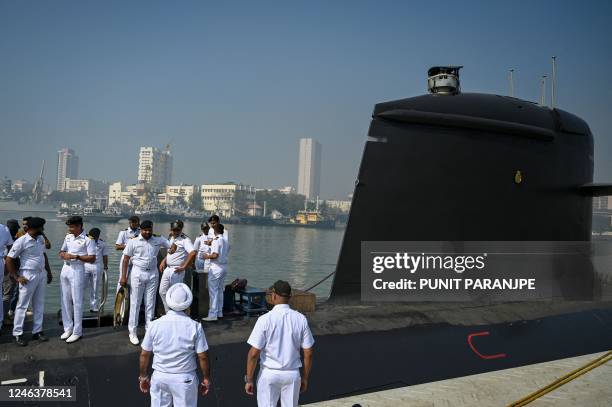 Indian navy officers interact on the deck of fifth Kalvari-Class submarine 'Vagir' anchored at the naval base ahead of its commissioning ceremony in...