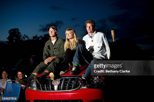 Top Gun fans Christian Evans, Miriam Smith and Jack Ingleby sit on the bonnet of their car to watch an outdoor viewing of Hollywood blockbuster Top...
